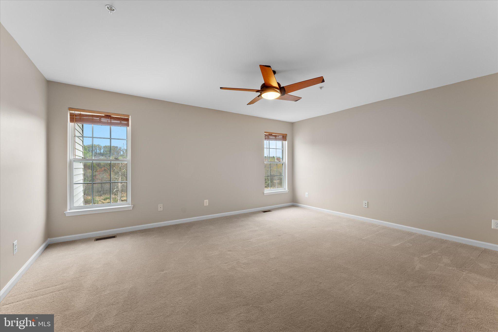 6696 Stream View Lane Warrenton, VA 20187 - Photo 24 of 57 an empty room with windows and fan