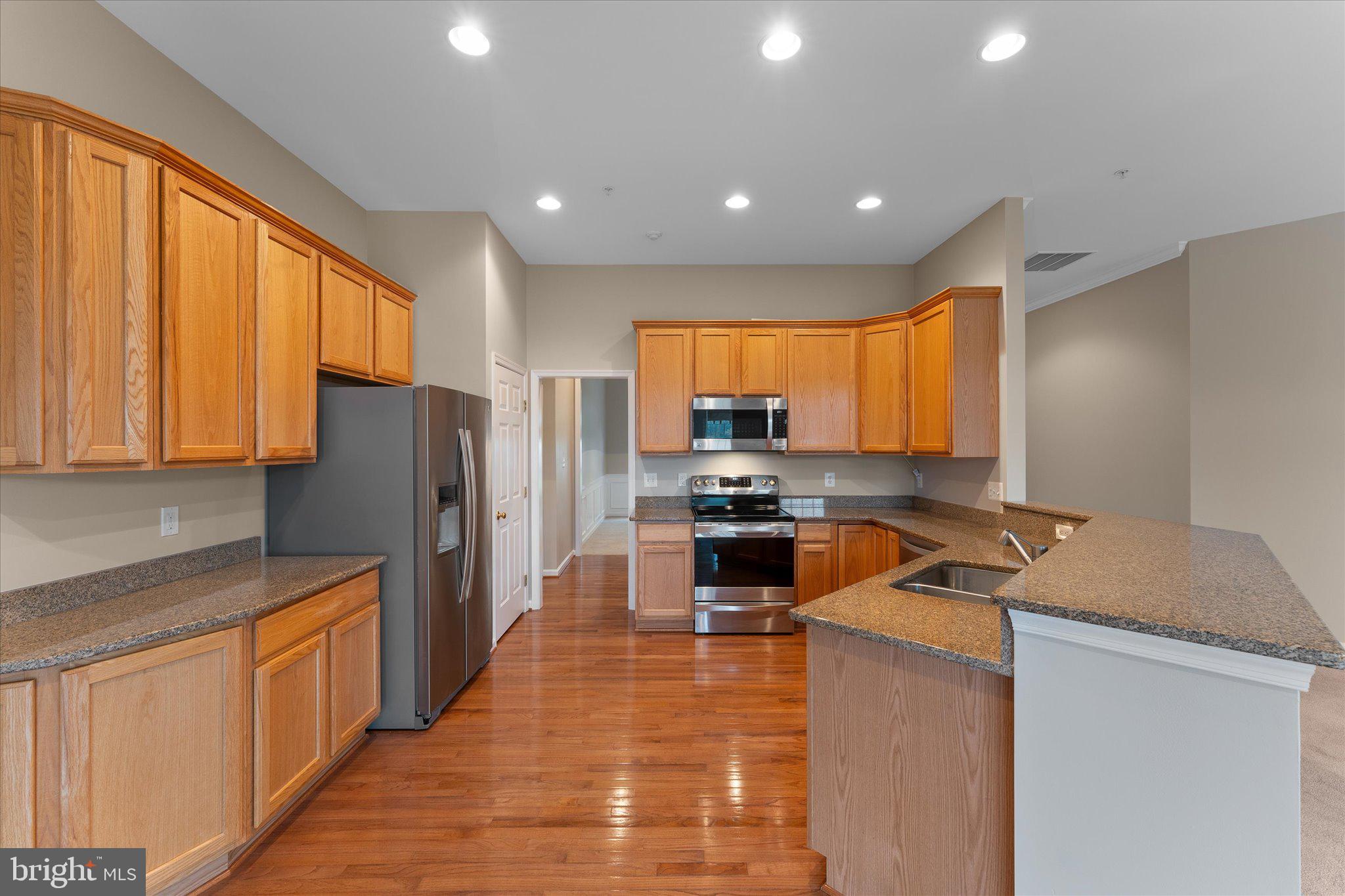 6696 Stream View Lane Warrenton, VA 20187 - Photo 9 of 57 a kitchen with refrigerator a stove a sink and a microwave