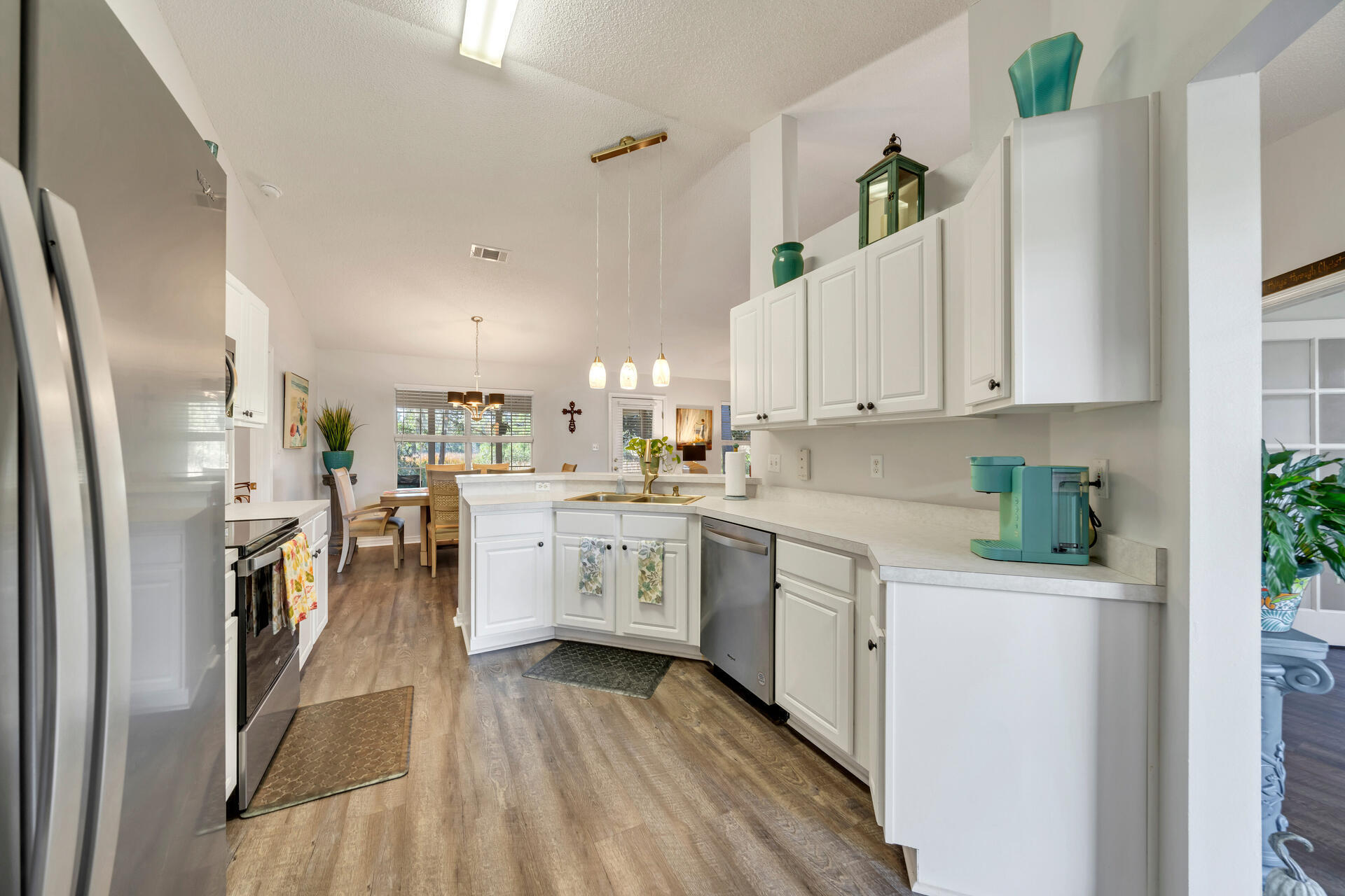 262 Beacon Way Miramar Beach, FL 32550 - Photo 11 of 42 a kitchen with white cabinets and refrigerator