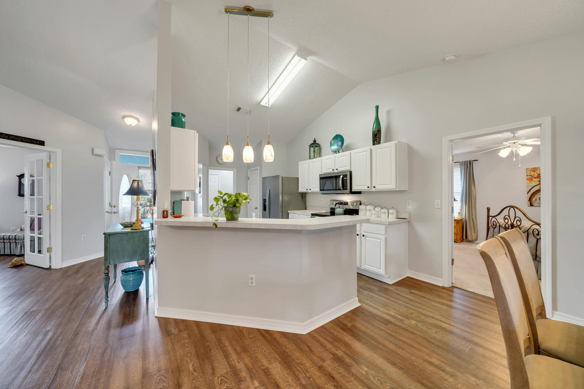 262 Beacon Way Miramar Beach, FL 32550 - Photo 13 of 42 a kitchen with stainless steel appliances granite countertop a refrigerator a stove top oven a sink dishwasher and white cabinets with wooden floor