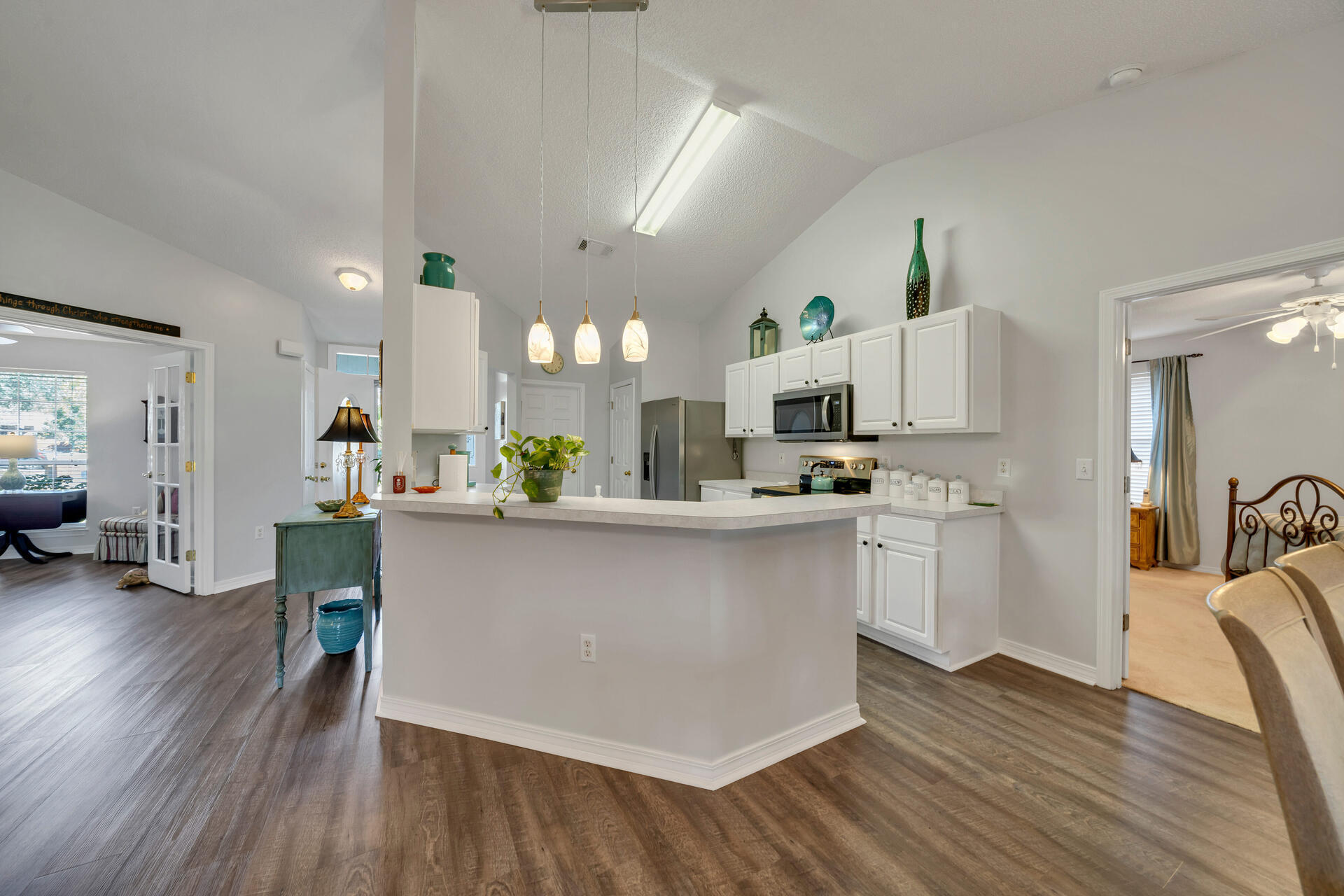 262 Beacon Way Miramar Beach, FL 32550 - Photo 15 of 42 a large white kitchen with lots of counter space a sink refrigerator and cabinets