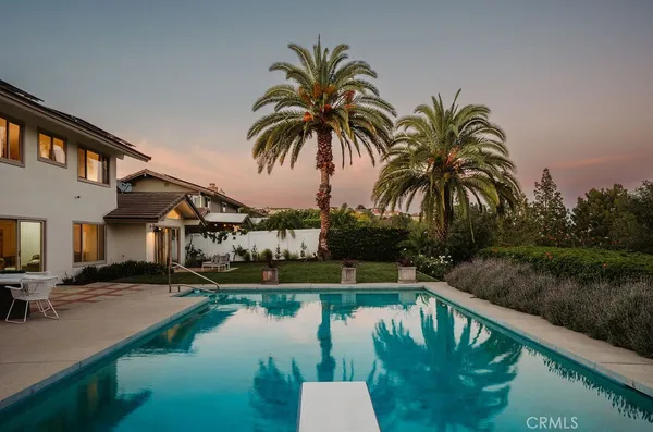 a swimming pool with outdoor seating and lake view