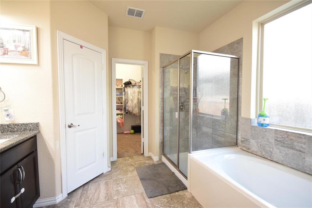 12421 Hitch Rack Way McKinney, TX 75071 - Photo 8 of 21 a bathroom with a granite countertop bathtub shower sink and mirror