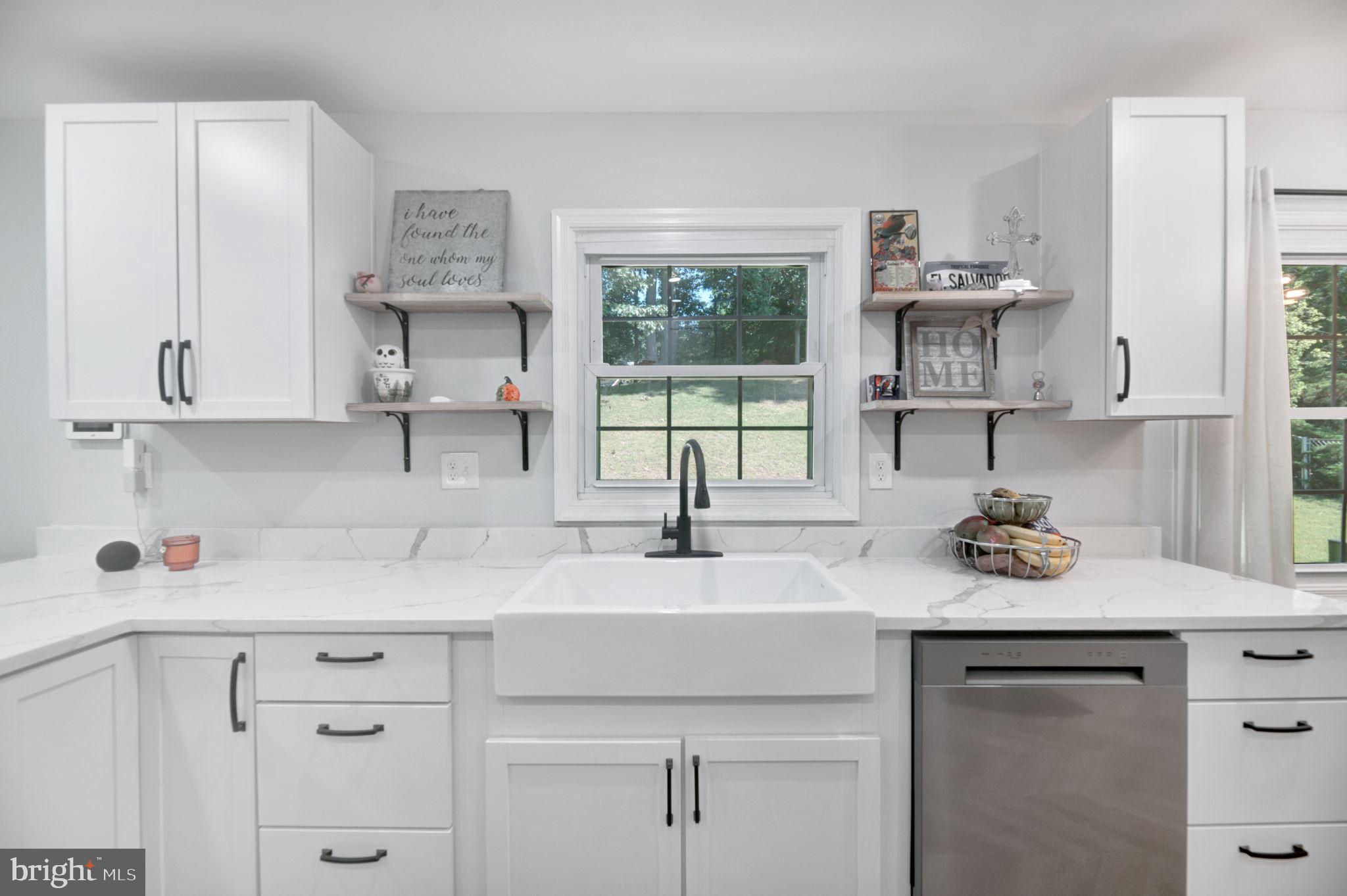 8812 Churchfield Lane Laurel, MD 20708 - Photo 5 of 31 a kitchen with stainless steel appliances granite countertop a sink a stove and cabinets