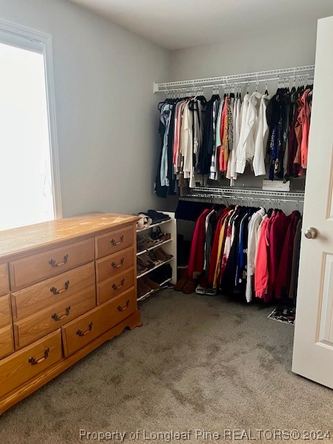 392 Buffalo Creek Road Raeford, NC 28376 - Photo 15 of 34 a view of walk in closet with clothes
