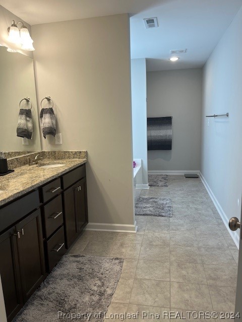392 Buffalo Creek Road Raeford, NC 28376 - Photo 30 of 34 a bathroom with a sink and a mirror