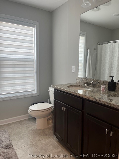 392 Buffalo Creek Road Raeford, NC 28376 - Photo 31 of 34 a bathroom with a granite countertop sink toilet and mirror