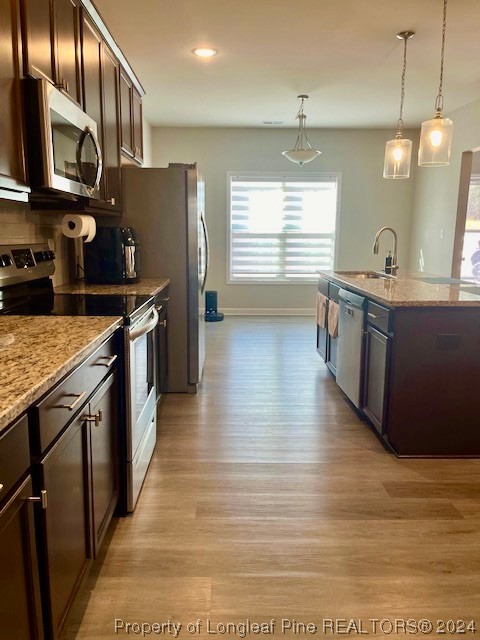 392 Buffalo Creek Road Raeford, NC 28376 - Photo 5 of 34 a kitchen with stainless steel appliances granite countertop a sink a stove and a wooden floors