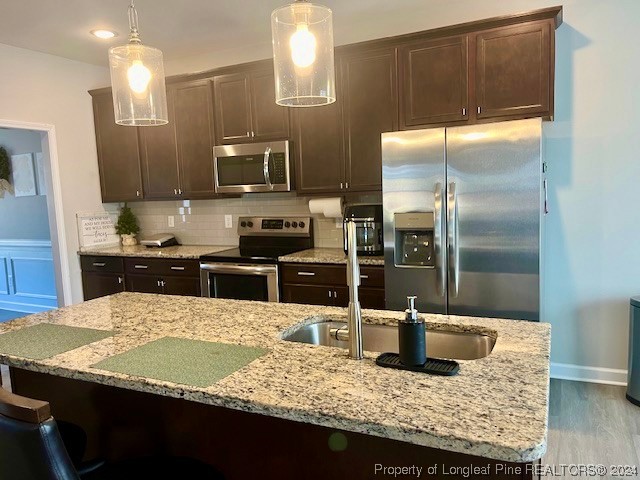 392 Buffalo Creek Road Raeford, NC 28376 - Photo 6 of 34 a kitchen with kitchen island granite countertop a sink refrigerator and microwave