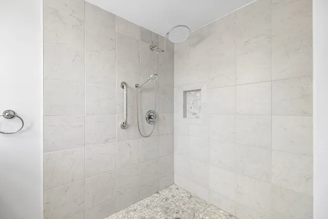 a bedroom with a bed and a large window with outer view