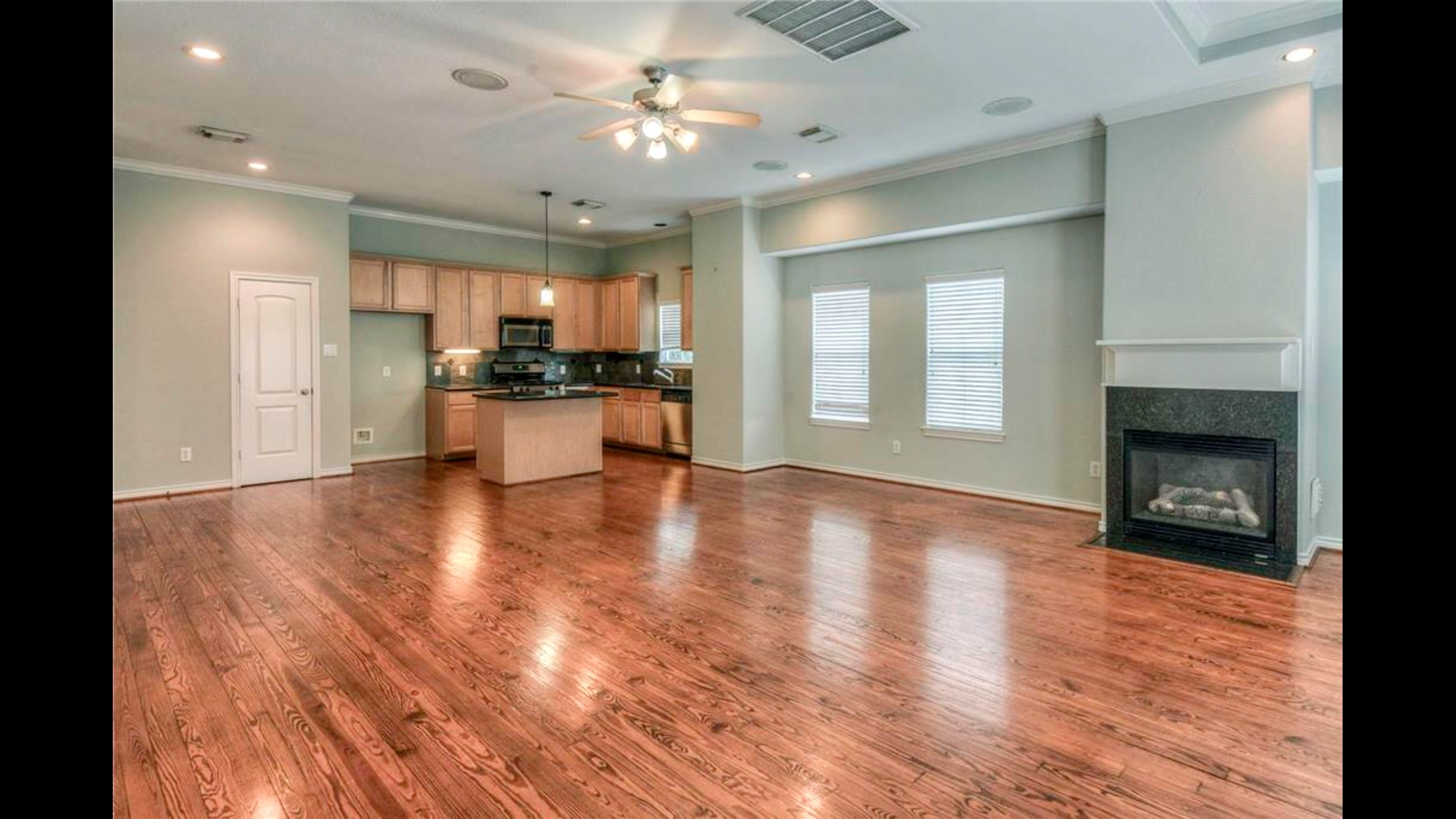 5415 Kansas Street Houston, TX 77007 - Photo 3 of 10 a view of a kitchen and a livingroom with a fireplace