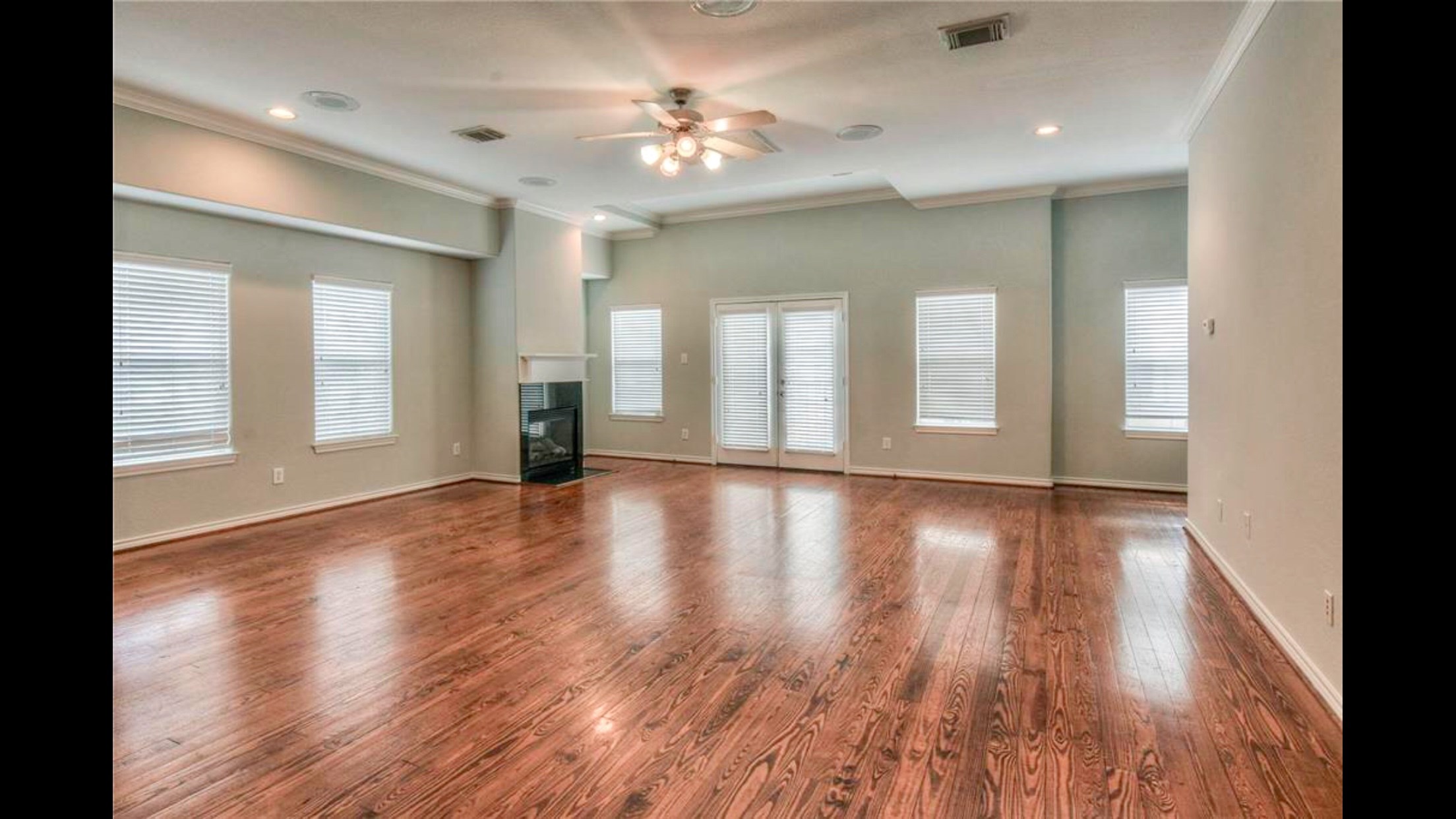 5415 Kansas Street Houston, TX 77007 - Photo 4 of 10 wooden floor in an empty room with a window