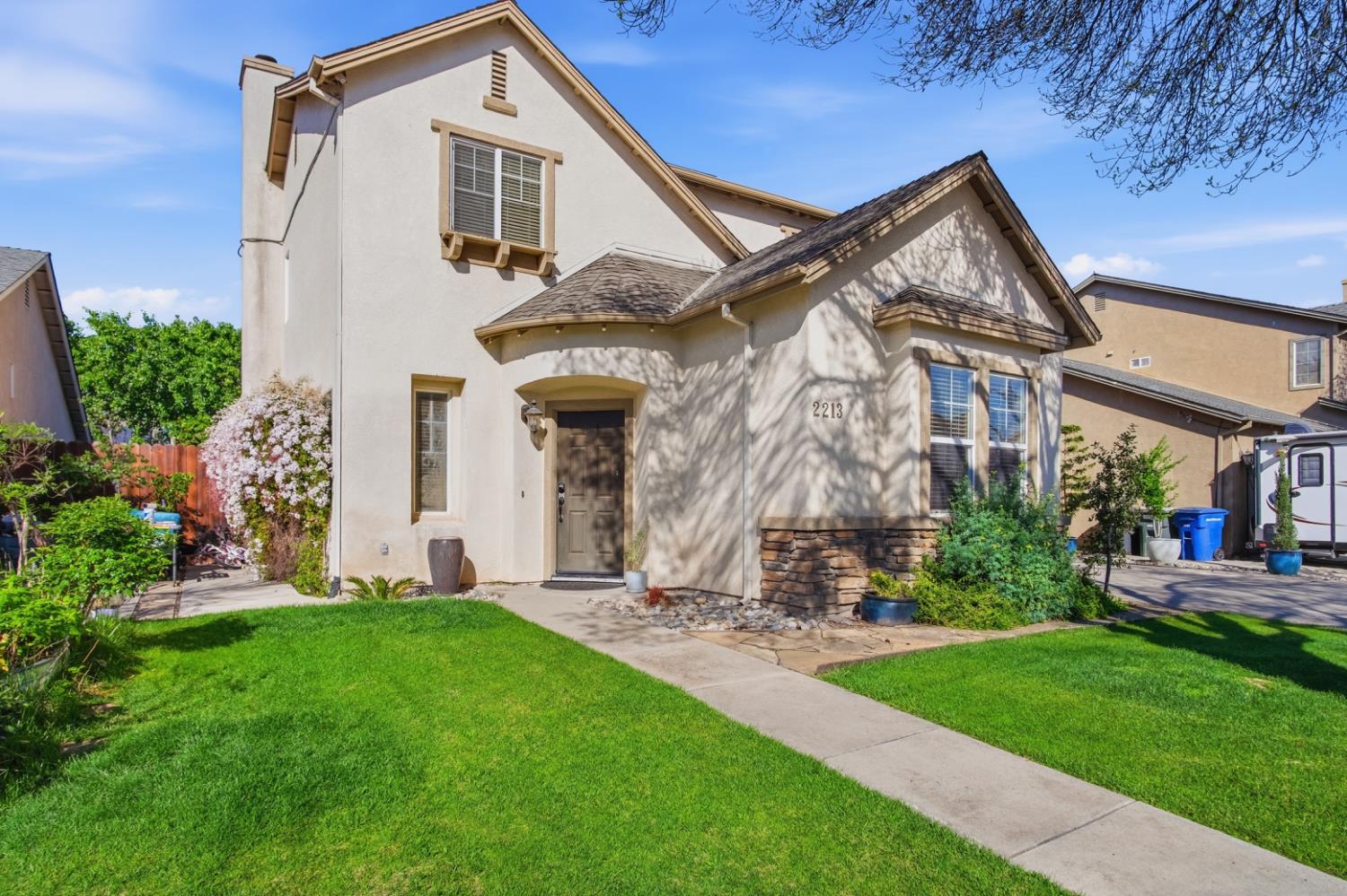 2213 Lionudakis Court Modesto, CA 95355 - Photo 1 of 38 a front view of a house with a yard and trees