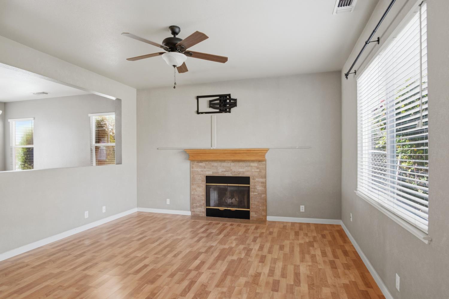 2213 Lionudakis Court Modesto, CA 95355 - Photo 13 of 38 wooden floor fireplace and windows in an empty room