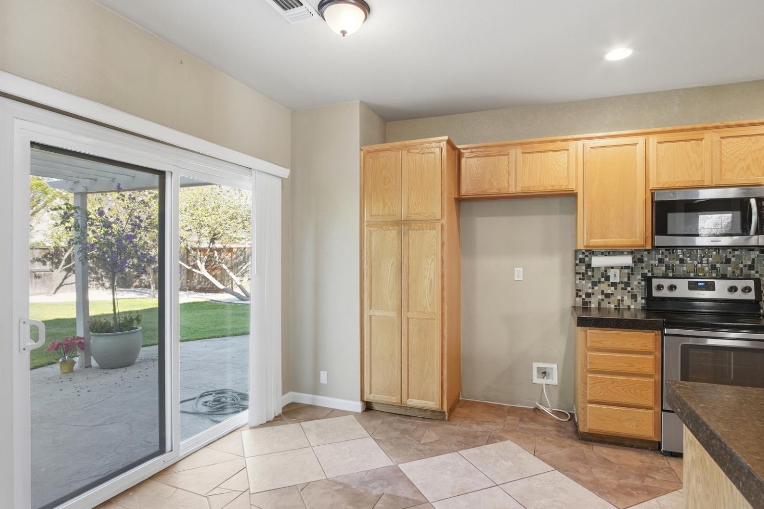 2213 Lionudakis Court Modesto, CA 95355 - Photo 15 of 38 a view of kitchen with windows and refrigerator