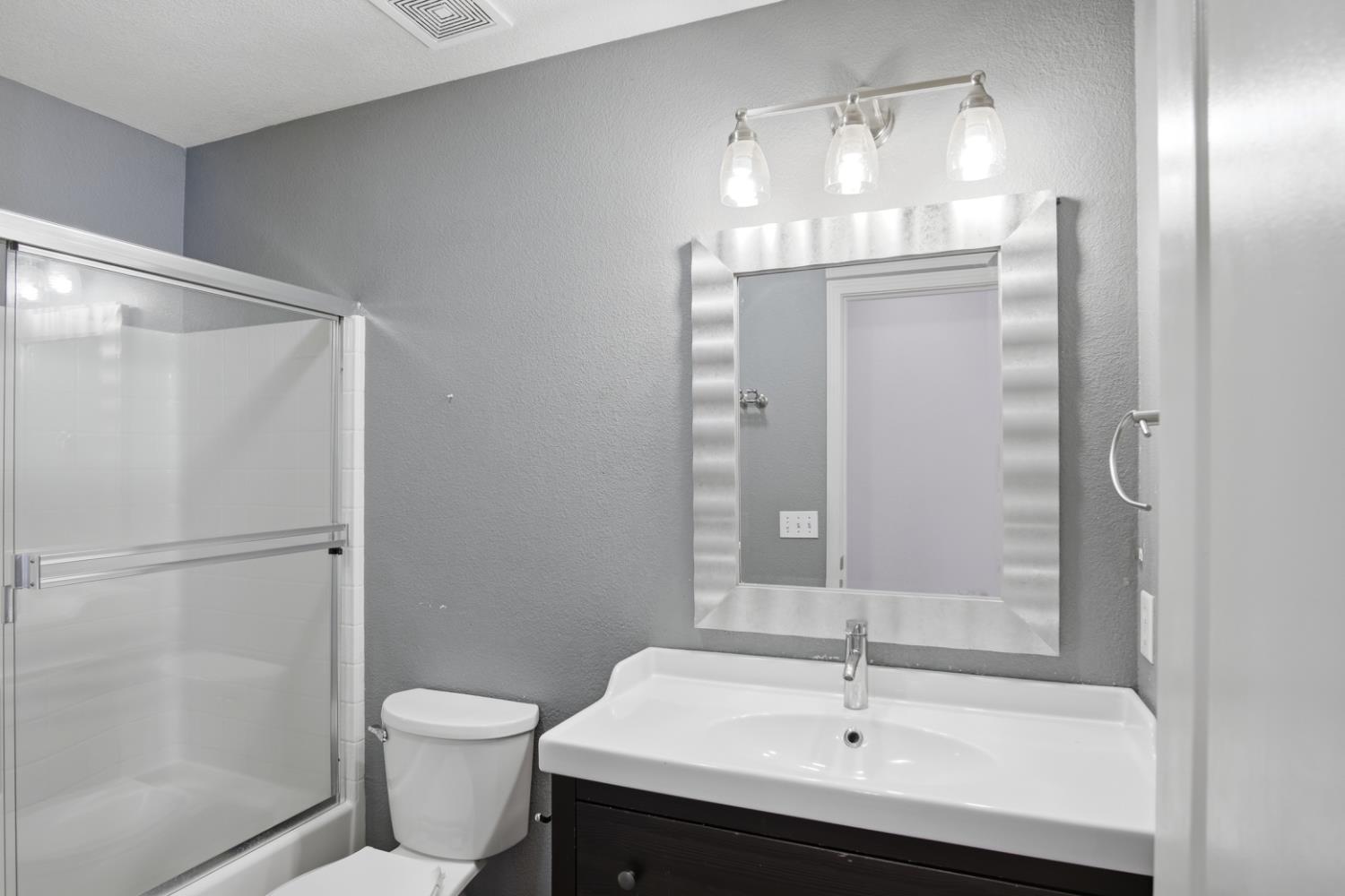 2213 Lionudakis Court Modesto, CA 95355 - Photo 21 of 38 a bathroom with a sink a toilet and shower