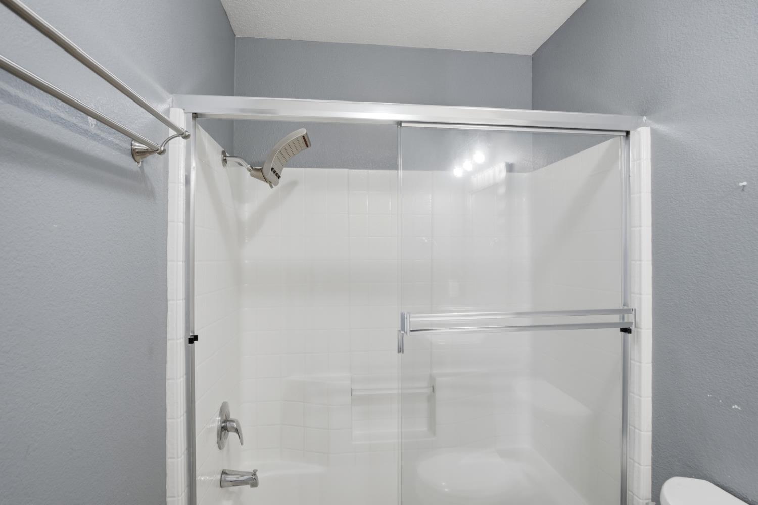 2213 Lionudakis Court Modesto, CA 95355 - Photo 22 of 38 a bathroom with a glass shower door