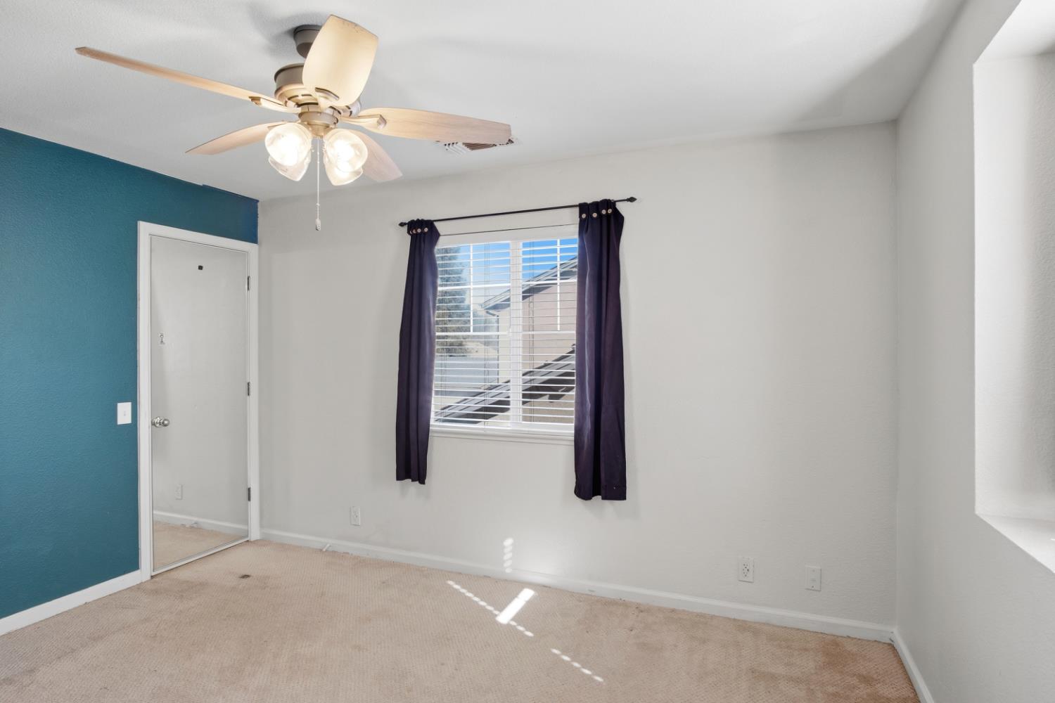 2213 Lionudakis Court Modesto, CA 95355 - Photo 23 of 38 an empty room with windows and fan