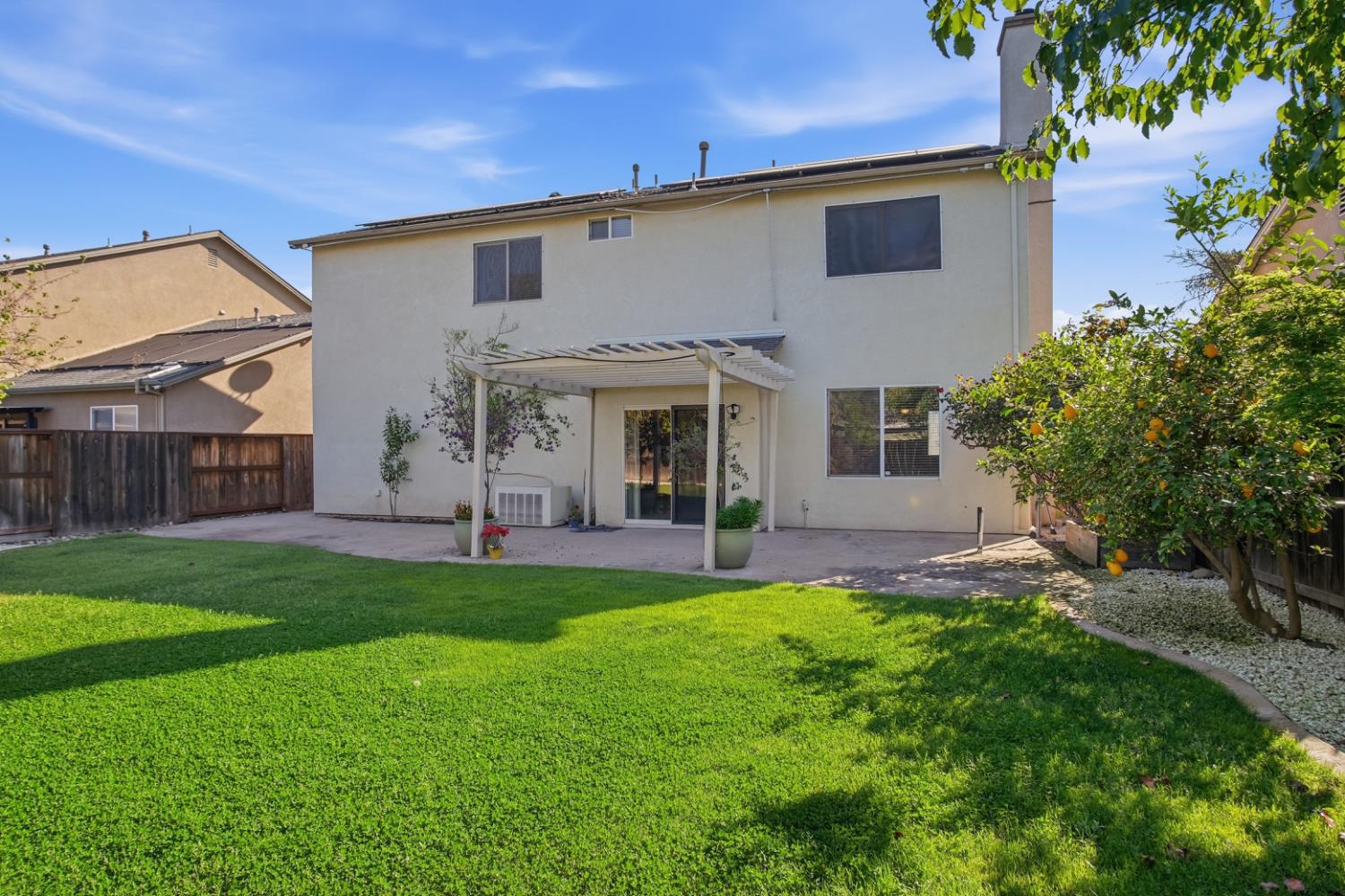 2213 Lionudakis Court Modesto, CA 95355 - Photo 29 of 38 a front view of a house with a yard and outdoor seating