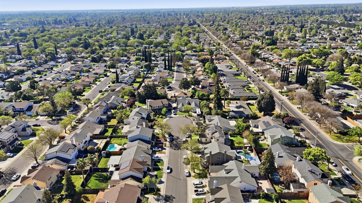 2213 Lionudakis Court Modesto, CA 95355 - Photo 36 of 38 an aerial view of a city with lots of residential buildings