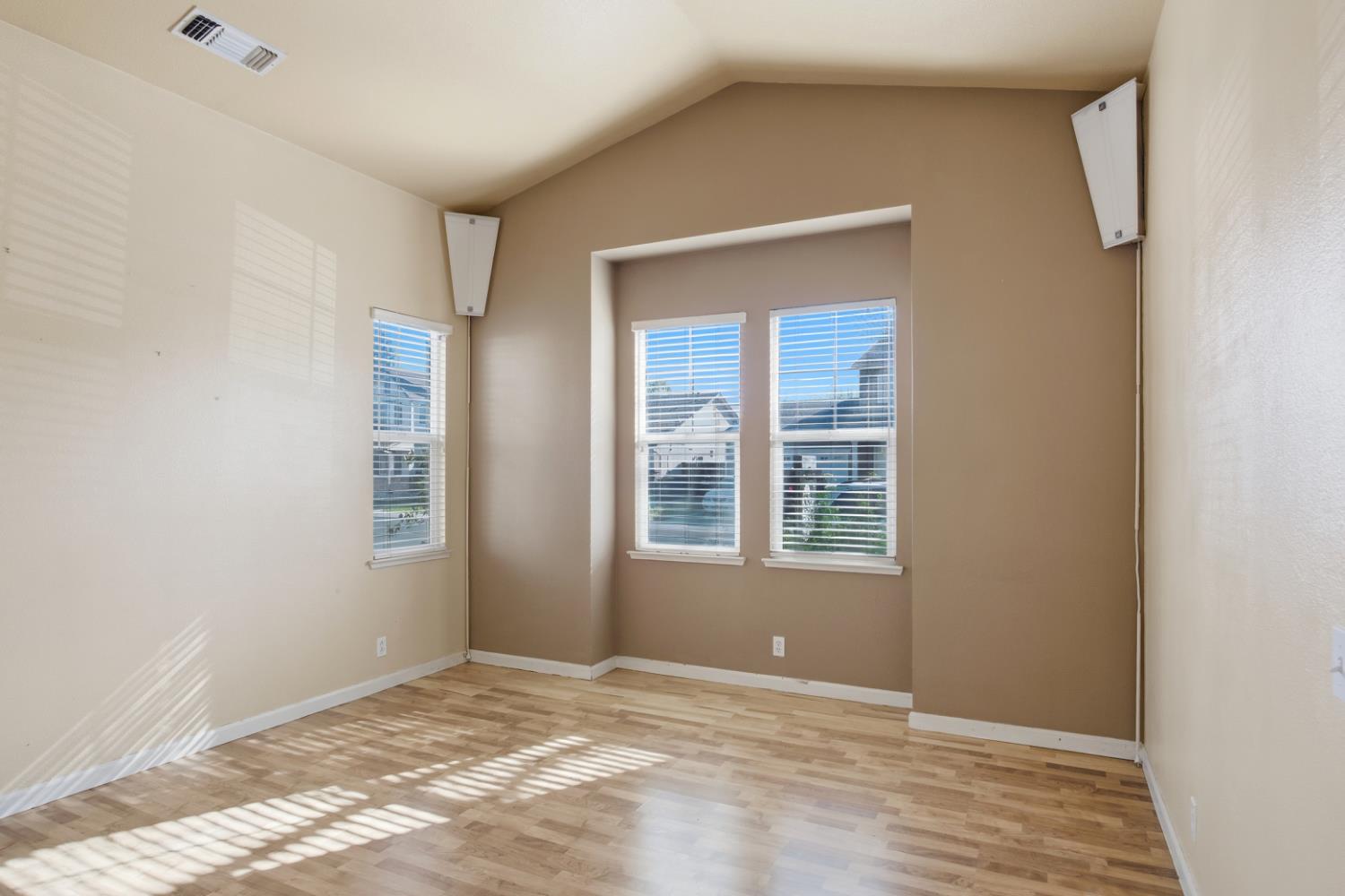 2213 Lionudakis Court Modesto, CA 95355 - Photo 6 of 38 a view of an empty room with window and wooden floor