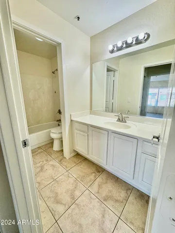 a bathroom with a sink a toilet and mirror