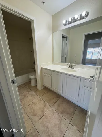 an empty room with an entryway and windows