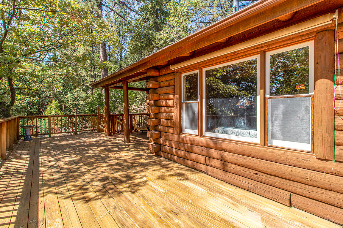 53174 Walters Drive Idyllwild, CA 92549 - Photo 21 of 55 a porch with a table and chairs next to a yard
