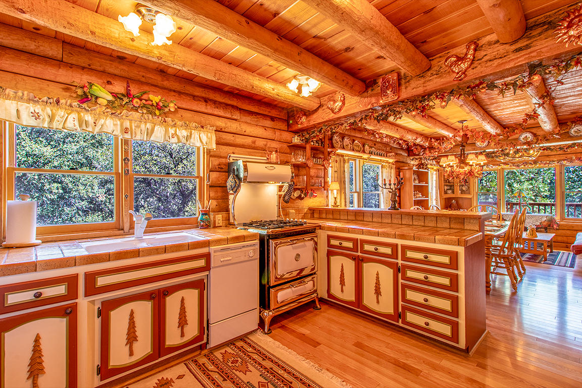 53174 Walters Drive Idyllwild, CA 92549 - Photo 36 of 55 a kitchen with stainless steel appliances granite countertop a stove and a wooden floors