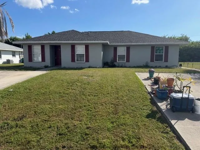 a view of a house with swimming pool and chairs