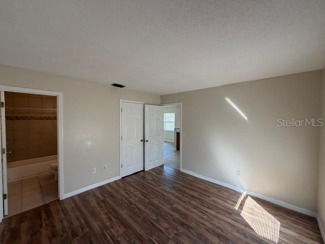 11089 Pendleton Avenue, Unit B Englewood, FL 34224 - Photo 15 of 19 a view of empty room with wooden floor