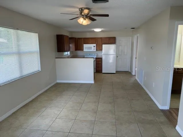 a view of a kitchen with a sink and a window