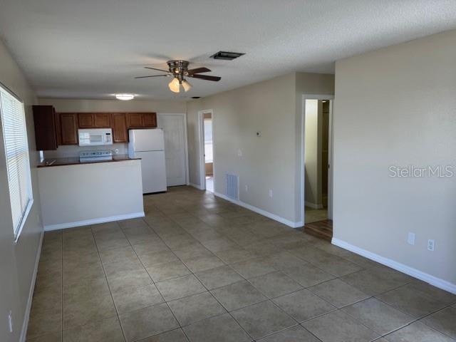 11089 Pendleton Avenue, Unit B Englewood, FL 34224 - Photo 5 of 19 a view of a kitchen with a sink and dishwasher cabinet a fireplace with wooden floor