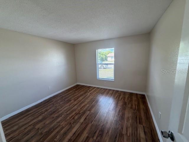 11089 Pendleton Avenue, Unit B Englewood, FL 34224 - Photo 8 of 19 an empty room with wooden floor and windows