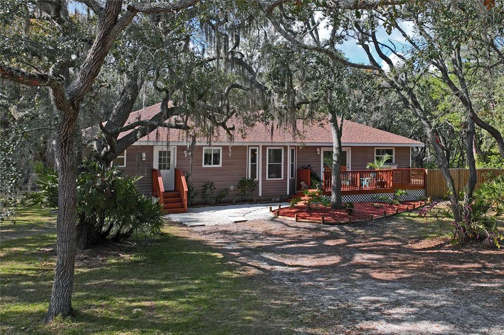 a view of a house with backyard porch and sitting area