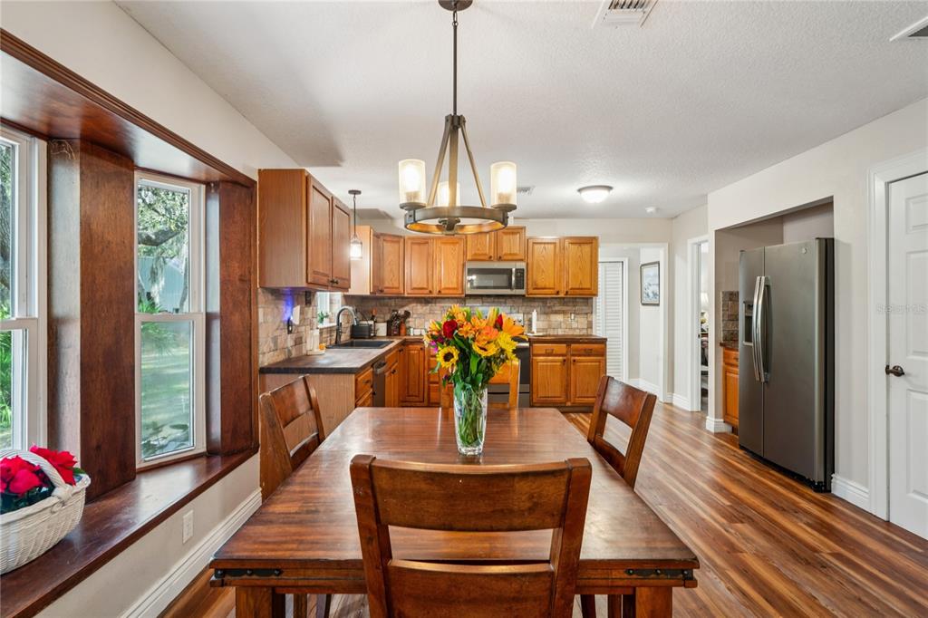 11185 Cleever Street Weeki Wachee, FL 34614 - Photo 20 of 61 a dining room with furniture a chandelier and window
