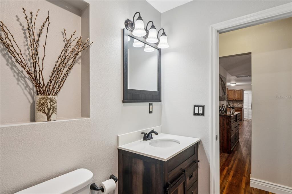 11185 Cleever Street Weeki Wachee, FL 34614 - Photo 32 of 61 a bathroom with a sink vanity and mirror