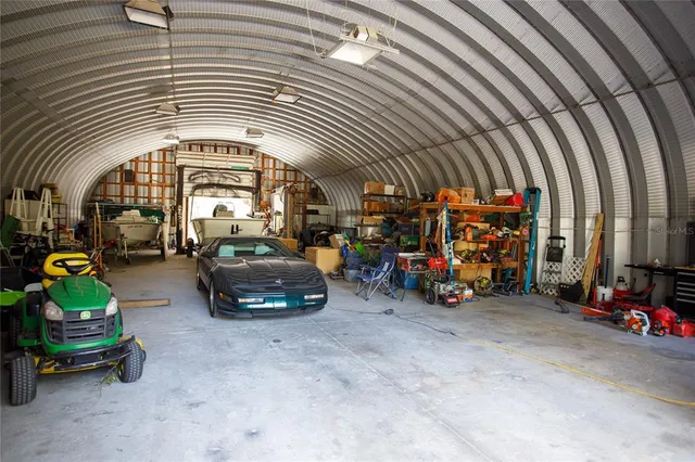 a kitchen with stainless steel appliances granite countertop wooden cabinets a stove top oven a sink and dishwasher with wooden floor