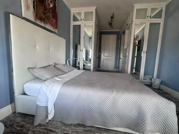 a bedroom with a bed and a mirror