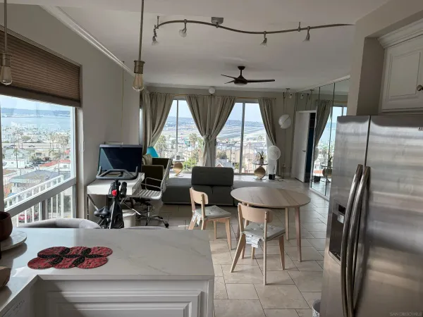 a living room with lots of furniture and a large window