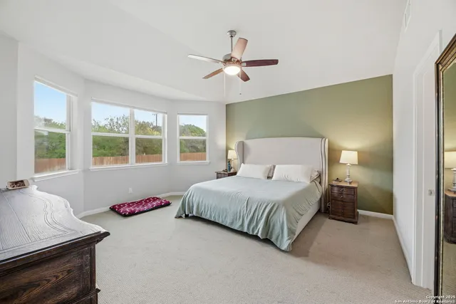 a bedroom with a large bed and a window