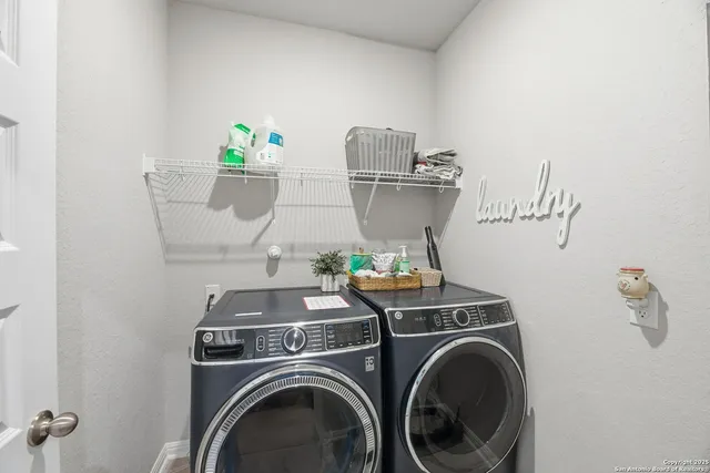 a view of a kitchen with white cabinets and wooden floor
