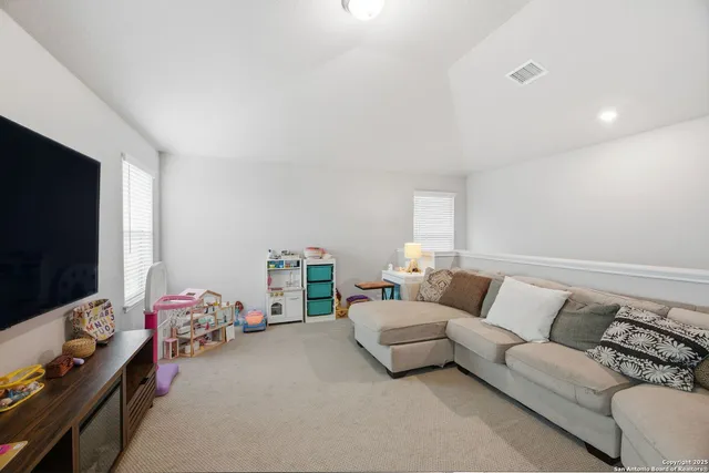 a living room with furniture and gym equipment