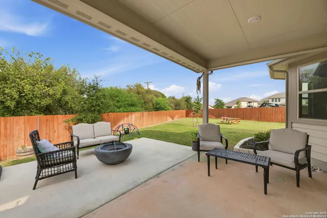 a view of a house with patio and a yard