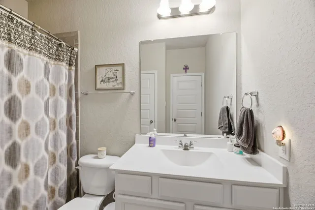 a living room with furniture flat screen tv and couches