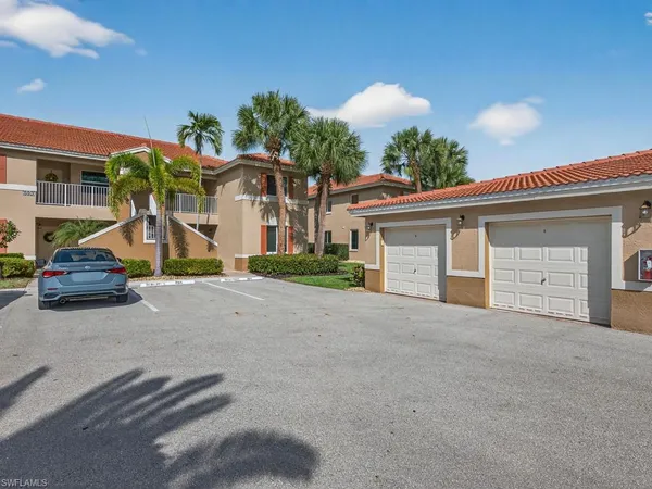 a view of a house with a yard and garage