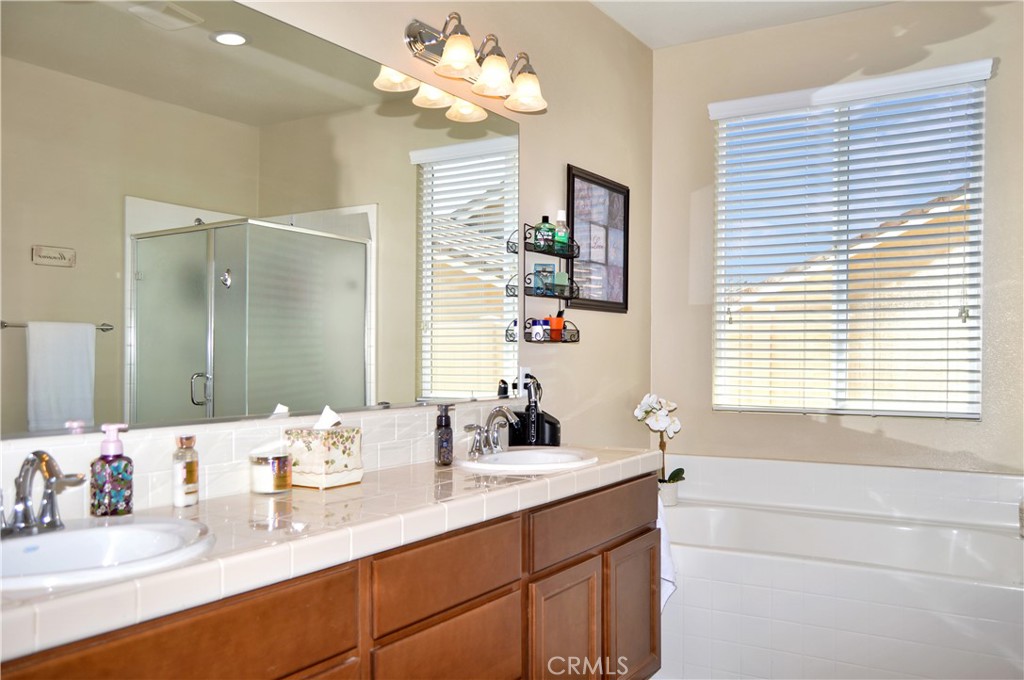 166 Fox Lane Calimesa, CA 92320 - Photo 37 of 76 Main Suite Bath with Dual Sinks, Soaking Tub, Glass-Enclosed Stall Shower, Private Toilet Room, and a Large Walk-in Closet