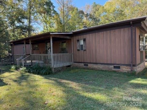 2622 Cimarron Circle Midland, NC 28107 - Photo 12 of 13 a view of backyard of house with wooden fence and trees