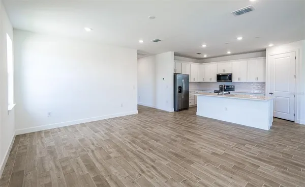 a view of kitchen with wooden floor
