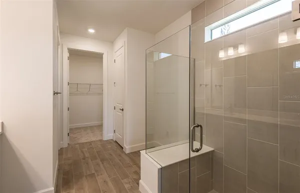 a bathroom with a shower and a sink
